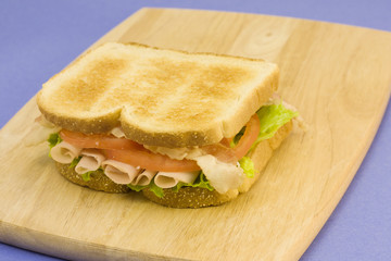 turkey club on cutting board