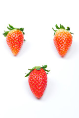 three strawberries isolated in white background