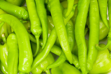 Many green hot peppers arranged at the market
