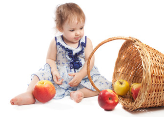 Fototapeta na wymiar Toddler sitting near fruit basket