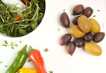 Mortar, pestle, herbs, peppers and olives