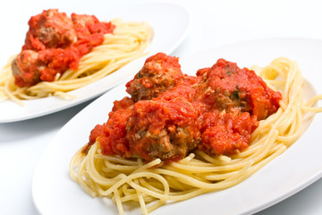 two servings on spaghetti with meatballs in tomato sauce