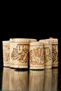 Wine corks on reflecting black background