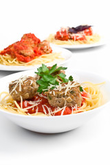 three servings of spaghetti with meatballs in tomato sauce