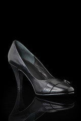 Luxurious designer shoes isolated against black background