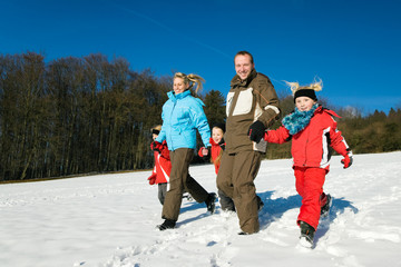 Family in the snow at a hill