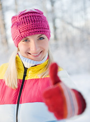 Happy young woman in winter clothing outdoors