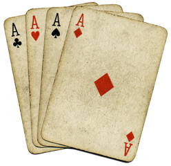 Four old vintage dirty aces poker cards, isolated over white.