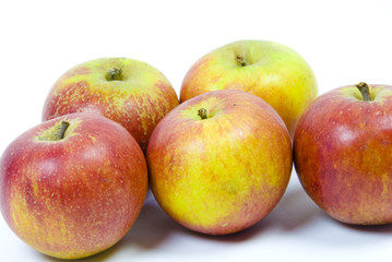 Fototapeta na wymiar five ripe english cox's pippin apples on white background