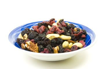 blue and white bowl filled with fruit and nuts