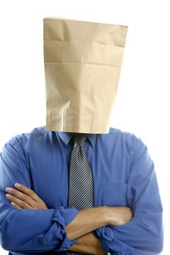 Businessman with paper bag in head