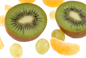 fruits, kiwi parts and mandarin segments, vine, on white