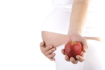 Pregnant woman holding apple. Nine month. Third trimester.