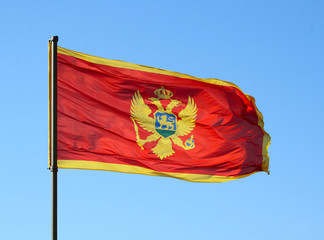 Flag of Montenegro on a blue sky