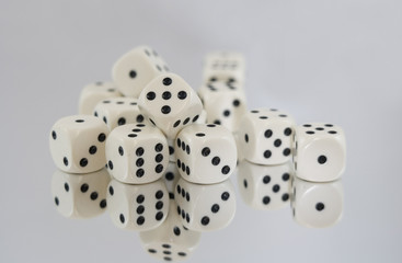 Multiple White dice with Black spots and reflections