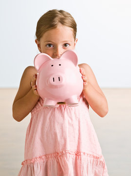 Girl Holding Piggy Bank