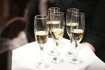 Waiter Carrying Glasses of Champagne on Tray
