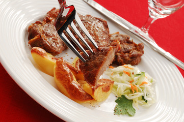 Grilled meat with baked potatoes and vegetable salad