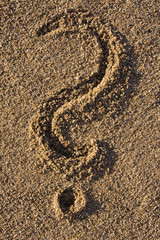 Fototapeta na wymiar question mark sign in sand