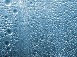 translucent blue glass with many rain drops