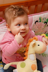 Closeup portrait of adorable baby girl  pointing her fist tooth