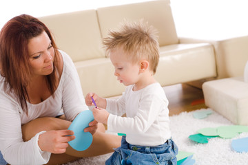 Mother and baby playing at home