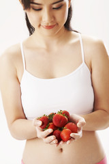 young woman holding strawberries