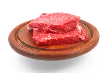 raw meat on wooden plate