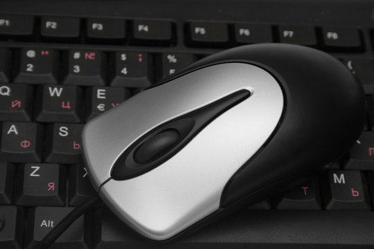 Computer mouse on the keyboard.