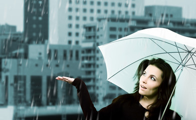 Beautiful young woman with white umbrella on rainy day