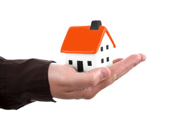 Fototapeta na wymiar human hand holding a small house