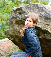 Portrait teen girl on big stone