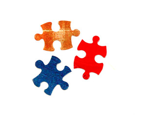 Obraz premium three colorful pieces of puzzle isolated on white background