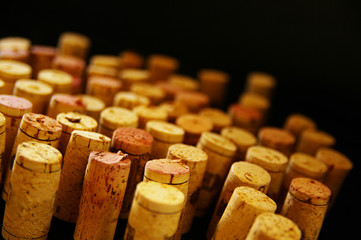 assortment of wine corks, on dark background