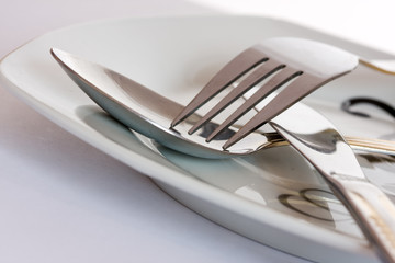 Fork, knife and spoon on a plate