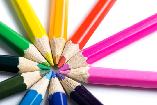 colored pencils in round shape isolated