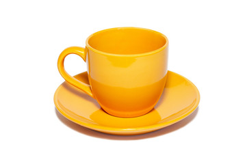 Orange ceramic cup and saucer isolated on white.