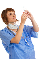 Young Caucasian female doctor inspecting filled syringe