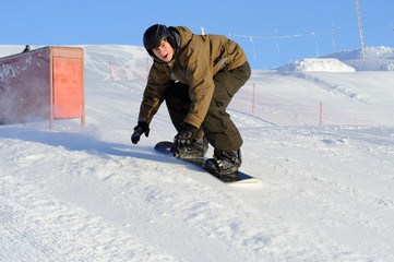 Fototapeta na wymiar Photo of a young male snowboarder jumping
