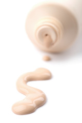 liquid foundation spilled out of bottle isolated