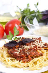 Spaghetti bolognese with cheese and raw ingredients
