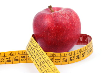 Apple and measuring tape on white