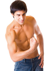 Fototapeta premium Portrait of muscular young man flexing biceps, isolated