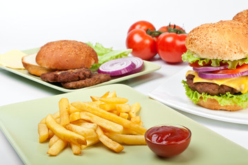two cheeseburgers and french fries and ingredients for another