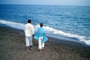 close up shot of attractive couple walking at the beach