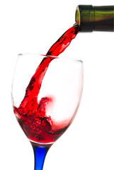 Red wine flowing to a glass. Isolated with a clipping path
