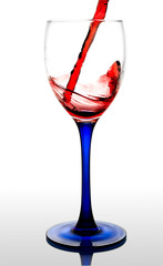 Red wine flowing to a glass. isolated with a clipping path