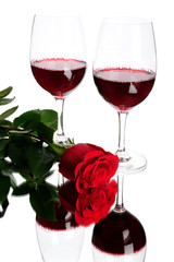 Two glasses of wine and rose isolated on white
