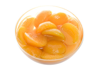 Apricot slices in glass bowl on white background