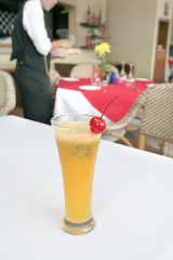 juice in restaurant with waiter at background